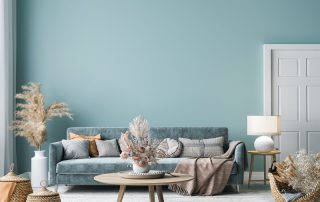 Soft blue-green painted living room walls with white trim door and gray upholstered sofa in Saint Charles, IL