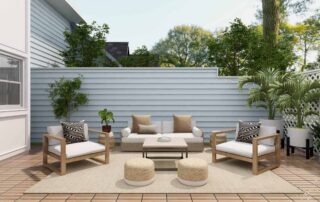 Light blue horizontal siding fence and home exterior with wood deck patio, seating area, and potted plants