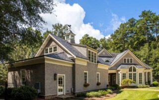 Cream and gray two-story residential home with white trim, dark roof, and stone foundation in Saint Charles, IL
